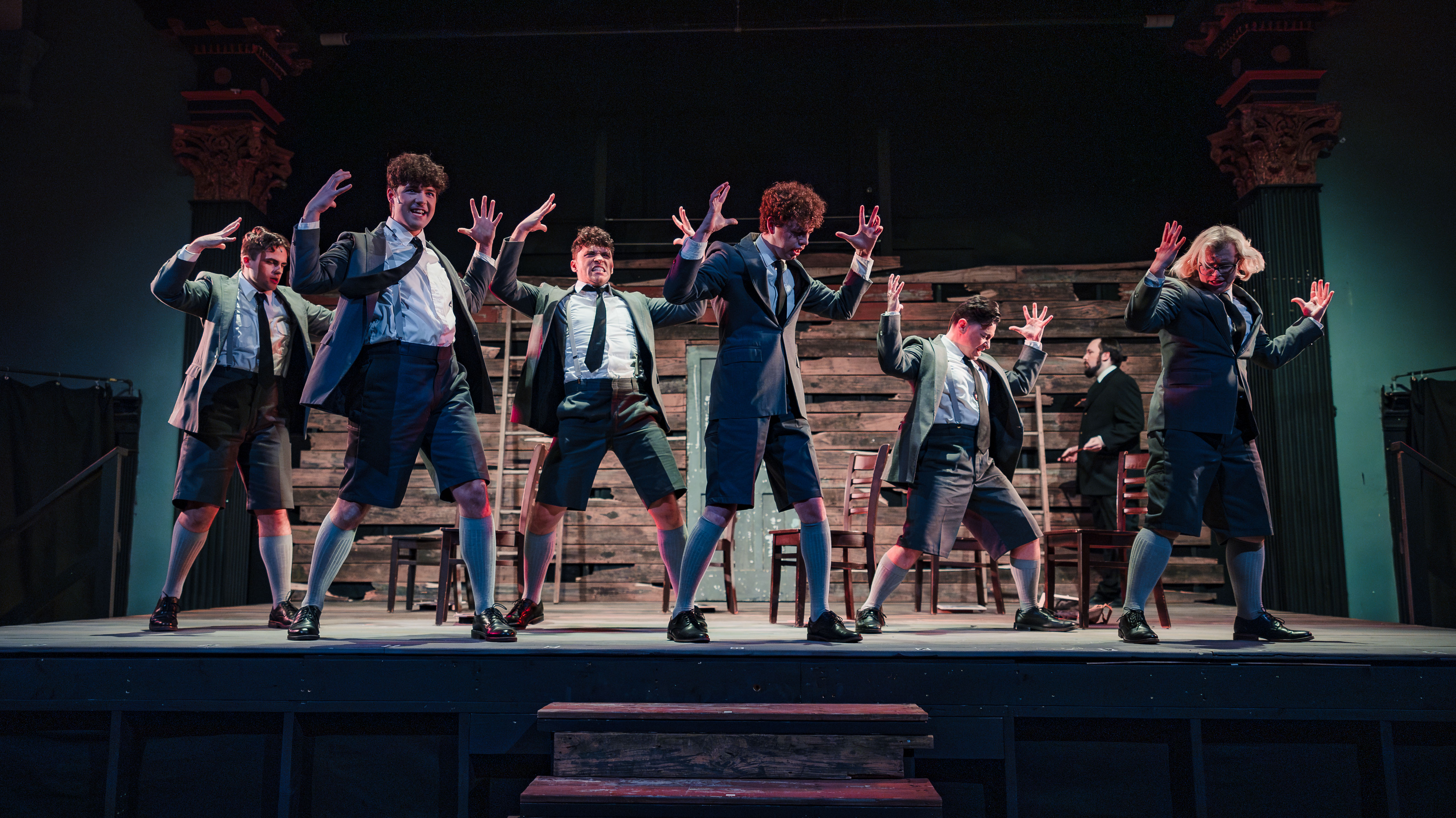Warm amber-lit stage moment from Spring Awakening